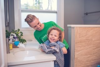 SitterTree babysitter helping kid wash hands during COVID